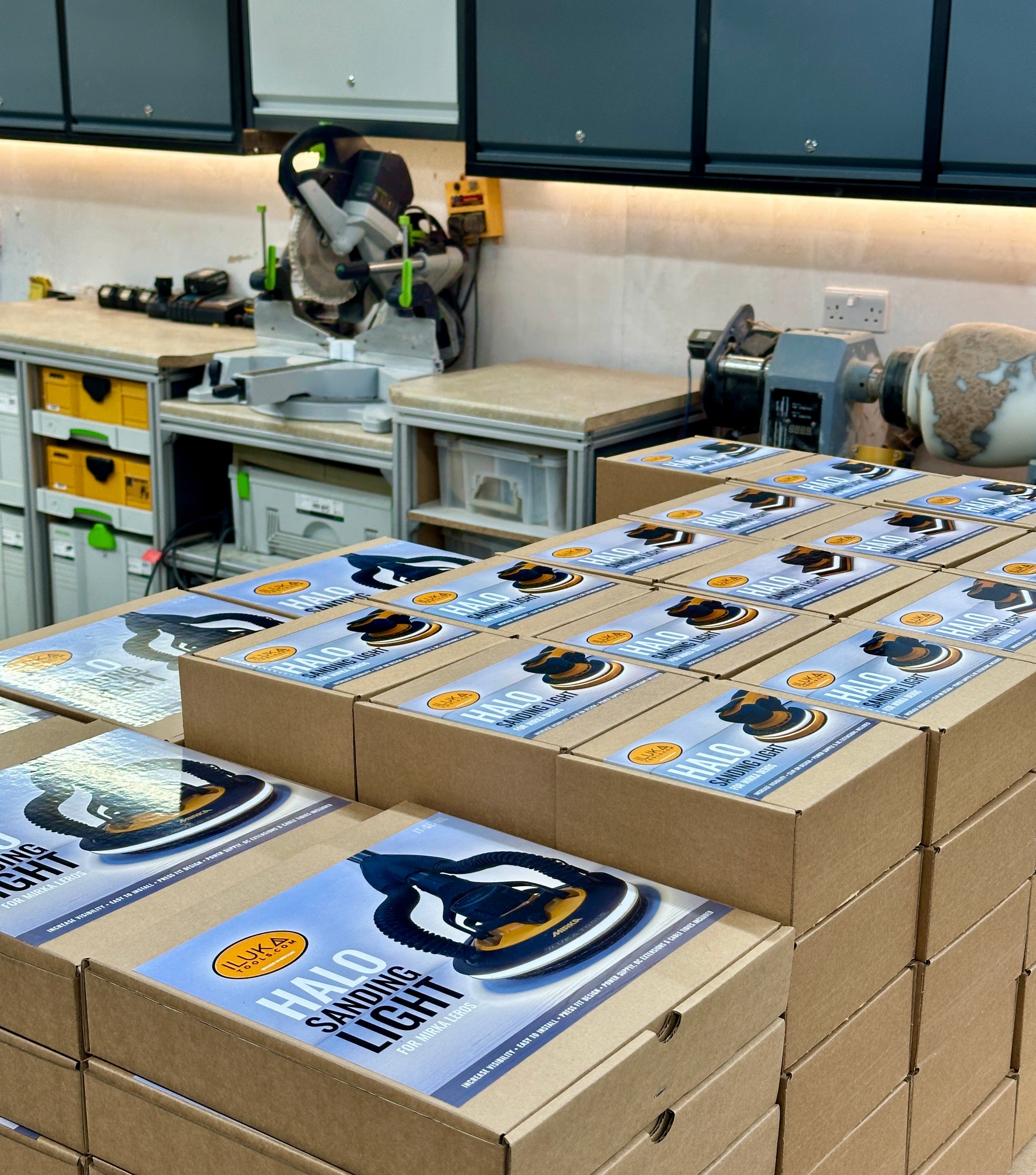 Stack of boxes with branded labels in a workshop setting